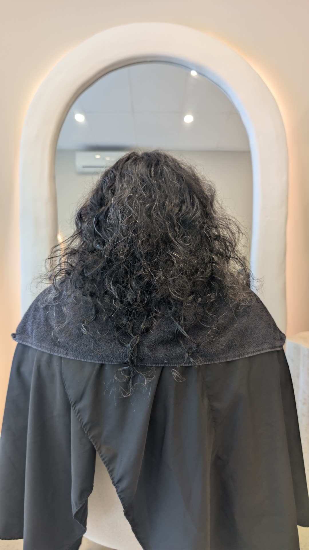 Dark frizzy curls before nanoplasty treatment